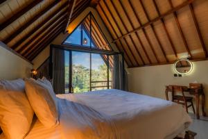 a bedroom with a large bed and a window at The Grembeng in Undisan
