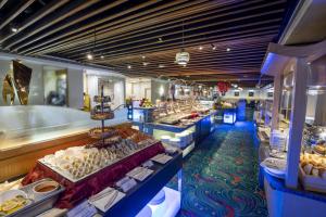 a buffet line with many different types of food at Metropark Hotel Kowloon Hong Kong in Hong Kong