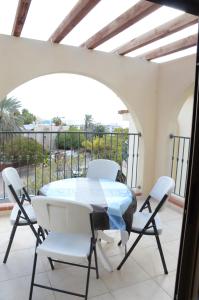 a table and chairs on the balcony of a house at Michelle`s Apartment in Eilat