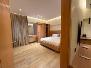 a hotel room with a bed and a bathroom at Hamsun DHA in Karachi +20 photos