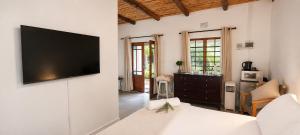a living room with a flat screen tv on a wall at Cedar Stay Clanwilliam in Clanwilliam