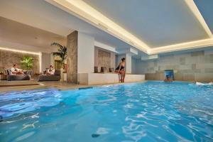 a woman in a swimming pool in a hotel at Appartamento Doglio Lux in Cagliari