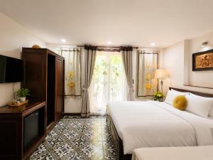 a hotel room with two beds and a window at Hanoi Luxury Hotel - Old Quarter in Hanoi