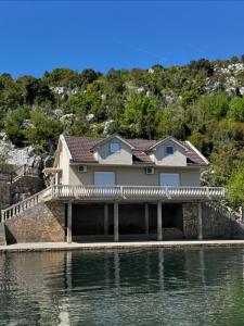 a house on the side of a body of water at Lakeside house in Podgorica