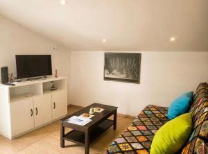 a living room with a couch and a tv at Casa Evita in Sanxenxo