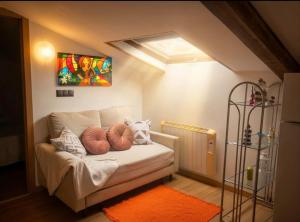 a bedroom with a couch with pillows on it at Casa Evita in Sanxenxo