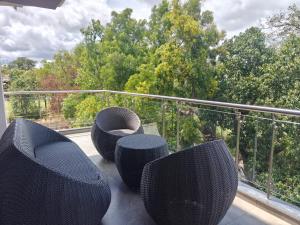 a balcony with black chairs and a railing at The Metro Hotel in Panhāla