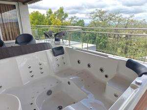 a bath tub sitting on top of a balcony at The Metro Hotel in Panhāla +22 photos