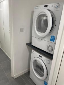 a washing machine and a dryer in a room at Private studio with a private bathroom and kitchenette in Edmonton +1 photo
