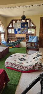 a bedroom with a bed and a hammock in it at Hidden Cabin in Iringa