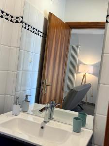 a bathroom with a sink and a mirror at Suite Terrazza Mazzini in Molinella