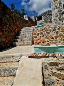 a set of stone stairs next to a stone wall at Ελαιόλιθοι Μάνη Villas 2 in Oitylo