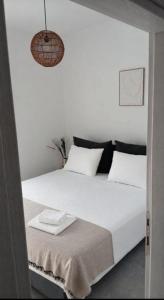 a bedroom with a large bed with white sheets at Ελαιόλιθοι Μάνη Villas 2 in Oitylo