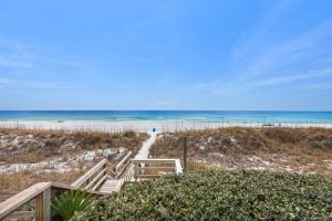 a stairway to the beach with the ocean in the background at Sea Oats Motel in Destin