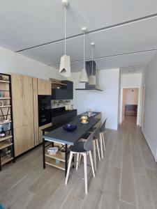 a kitchen and dining room with a table and chairs at Palase GC 141 in Palasë