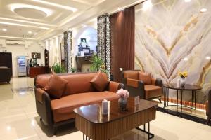 a lobby with a couch and tables in a building at إطلالة السيب للشقق المخدومة Itlalat Alseeb Serviced Apartments in Khafji