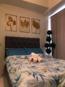 a bedroom with a bed with a book on it at Escapade in Tagaytay by JV in Kaybagal