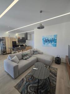 a living room with a couch and a table at Palase GC 141 in Palasë