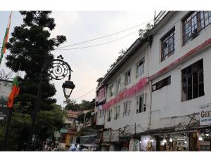 a city street with a street light and buildings at help hostel in Mussoorie