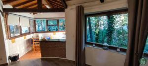 a kitchen with a large window in a house at Casa Rural Crisol Spa in Arenas de San Pedro