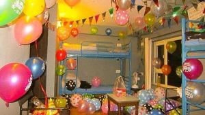 a room with balloons and a bunk bed with a lot of balloons at help hostel in Mussoorie