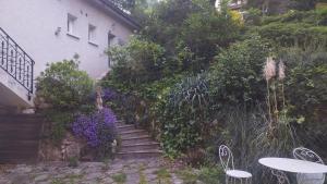 a garden with stairs and flowers next to a house at Duplex 2 personnes, maximum 6, sans vis-à-vis in Aix-les-Bains