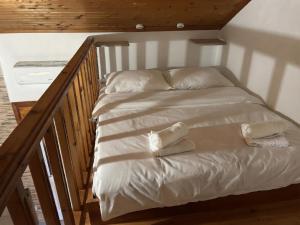 a bed with two pillows on it in a room at Denis House in Keramoti