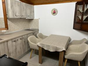 a kitchen with a table and chairs in a kitchen at Denis House in Keramoti