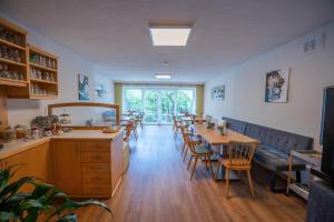 a restaurant with tables and chairs and a large window at Gästehaus Wulz-Lesjak in Egg am Faaker See