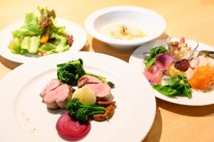 a table with three plates of food on it at かきぞれ大黒宿ー1日1組限定 築120年の古民家と貸切サウナ完備 in Nakakiri
