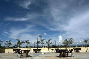 a group of tables and chairs under a cloudy sky at Hotel Grand Mayfair in Dimapur