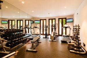 a gym with lots of treadmills and machines at Anapuri Villas in Ketewel