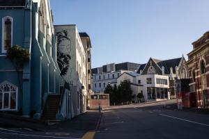 an empty street in a city with buildings at Chapel Apartments in Dunedin