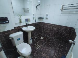 a bathroom with a white toilet and a sink at Kinmen Huan Bei 88 B&B in Jincheng +24 photos