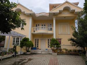 a large yellow house with a balcony at Heritage View Homestay, Kathmandu in Kathmandu +27 photos