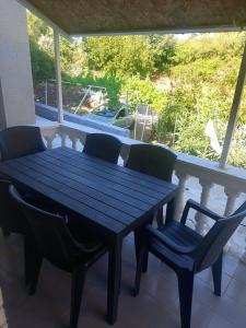 a blue wooden table and chairs on a porch at Luka1 in Sutomore