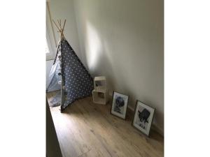 a room with two pictures on the floor next to a wall at Ferienhaus Bibernest in Münsingen
