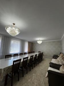 a conference room with a long table and chairs at Sultan in Kochkorka