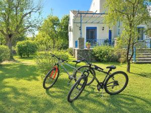 two bikes parked in the grass in front of a house at Villa Lefka Stunning Seaside Villa in Corfu with Private Gardens in Melíkia