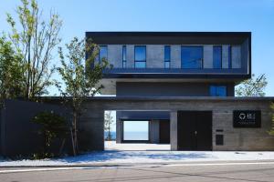 a modern house with a black door at THE THIRD PLACE tatéyama 楼 in Tateyama