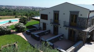 an aerial view of a house with a swimming pool at Paolimura Resort , Apartment & Spa in Aci Catena