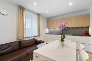 a living room with a couch and a white table at Apartments Mupan St. Vigil in San Vigilio Di Marebbe