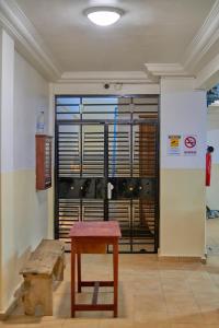 a room with a table and a bench and a window at RÉSIDENCE Chloé in Bonamoussadi +5 photos