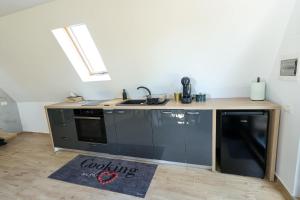 a kitchen with a sink and a counter top at CASA MAYA Câmpulung in Câmpulung