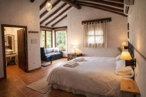 a bedroom with a large white bed and a couch at Casa Rural Crisol Spa in Arenas de San Pedro +97 photos