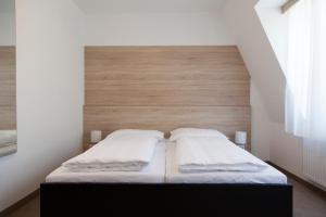 a bed with two pillows on it in a room at Seminarhotel Springer Schlössl in Vienna