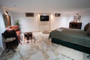 a bedroom with a bed and a tv in it at Medina Loft Your Artistic Escape in Rabat