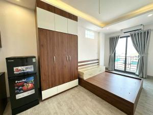 a large room with a refrigerator and a window at 25House Cozy Apartment near West Lake & Airport in Hanoi