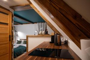 a room with a bed and a desk in a room at Uroczysko in Lesko
