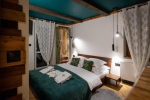 a bedroom with a bed with towels on it at Uroczysko in Lesko